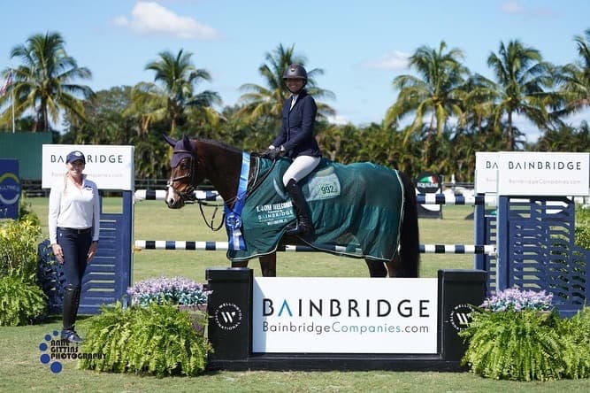 Emma Marlowe and a grey horse clearing a fence at the Winter Equestrian Festival in Wellington