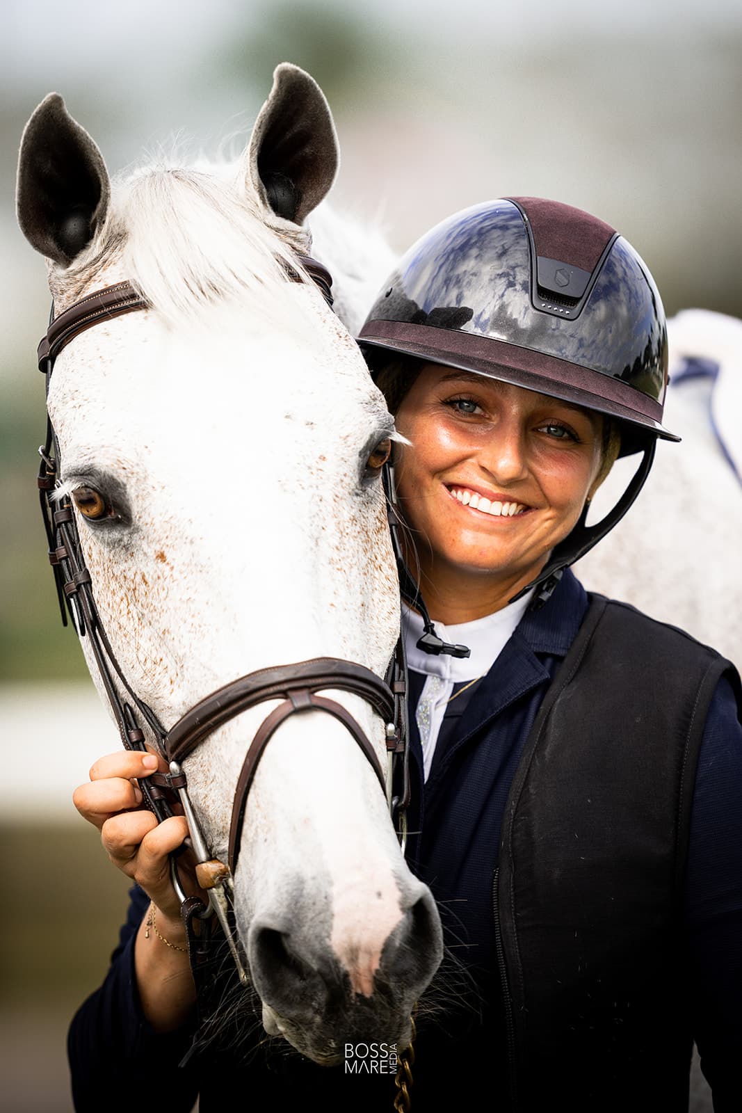 Emma Marlowe smiling on a bay horse between rounds
