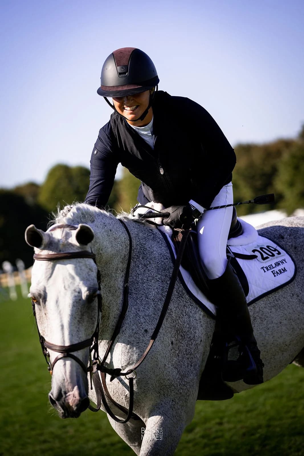 A grey gelding jumping an oxer in top form with Emma Marlowe in the irons
