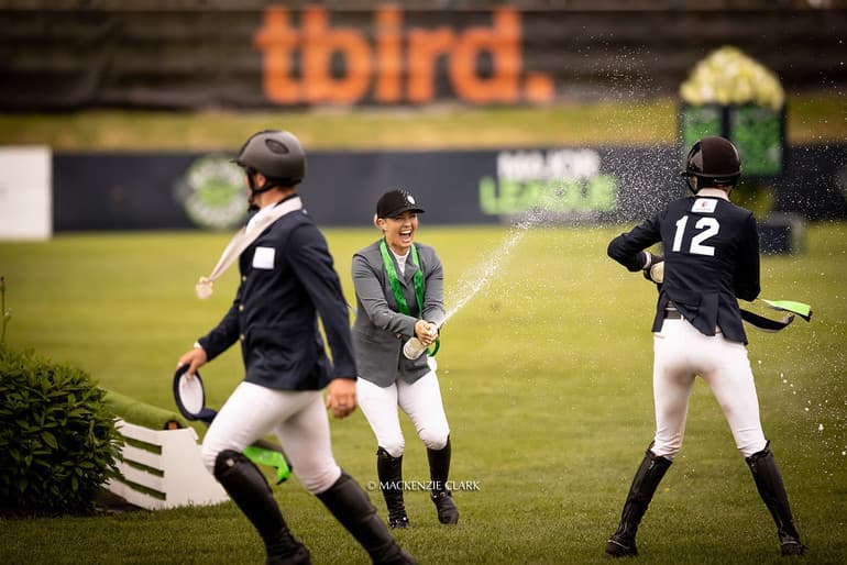 Emma Marlowe spraying champagne with teammates on the podium at a Major League Show Jumping event
